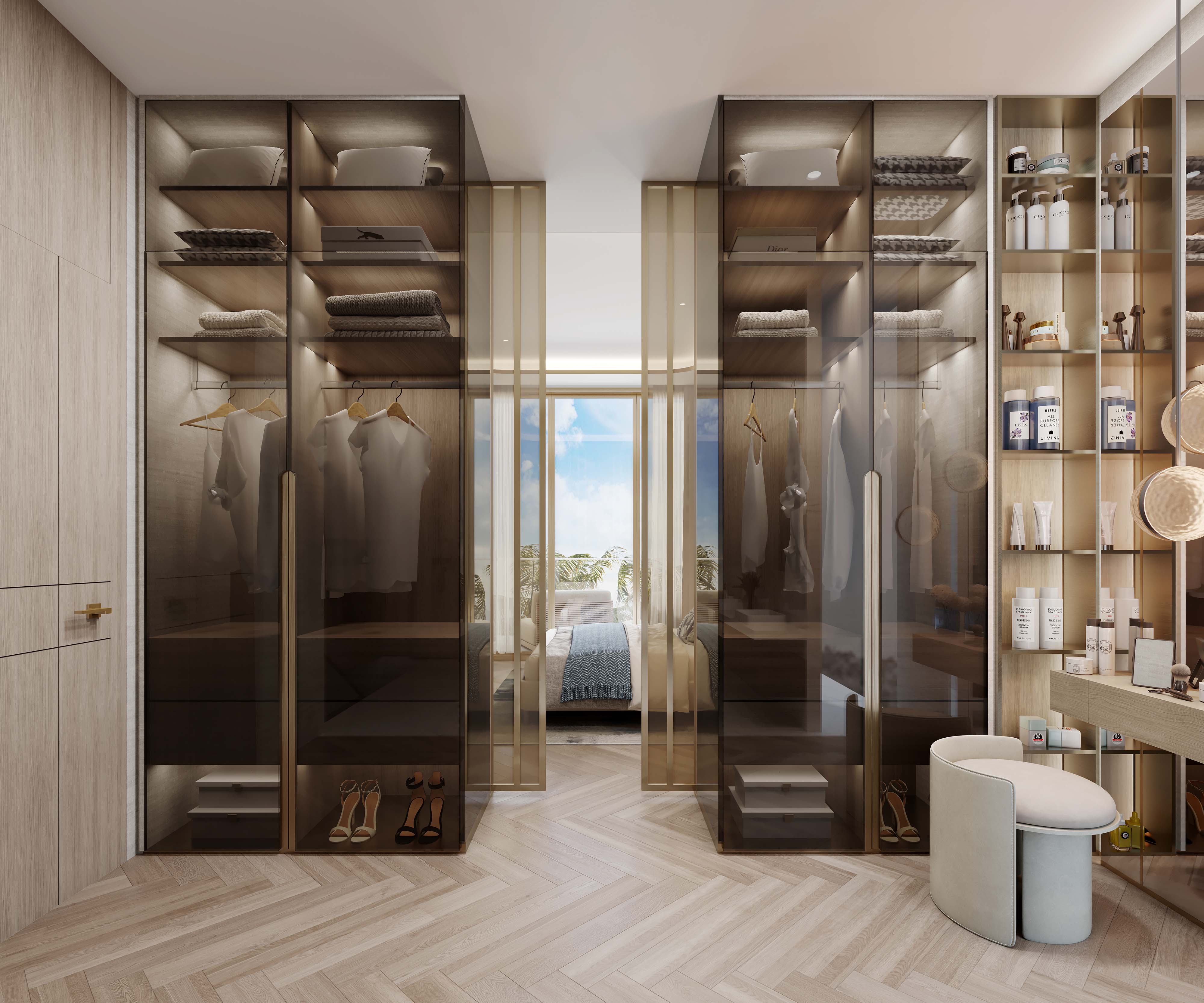 Sunset Bay 3 By Imtiaz A modern wardrobe area featuring transparent cabinets with organized clothing, shoes, and beauty products.